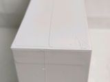 a white box sitting on the floor next to a toilet