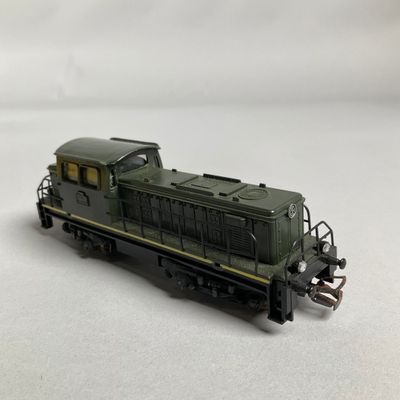 a toy train on a white surface with a white background