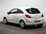 the back of a white car is parked in a white room