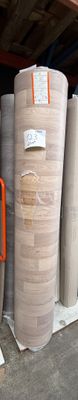 many rolls of paper on a shelf in a warehouse