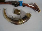 a very old gun and some other items on the table