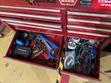 a red tool box with tools in it on the floor