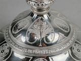 a silver plate with a decorative design on it