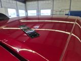 a remote control on the hood of a red car