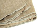 a close up of a folded blanket on a white surface