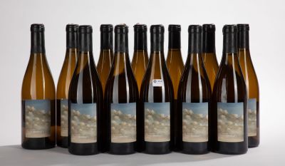 six bottles of wine are lined up in a row on a white surface