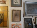 many framed pictures on the wall of this room