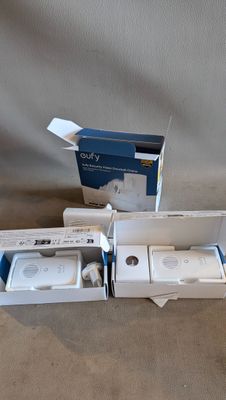 two wii controllers in the box on the floor