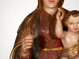 a statue of a woman holding a baby on her lap