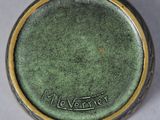 an image of a close up of a green vase on a table