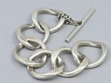 a silver bracelet with a chain attached to it