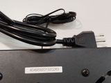a power cord that is plugged into a power strip