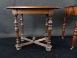 two wooden tables with turned legs and a table top on a black surface