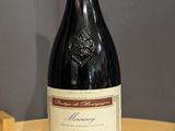 a bottle of wine sitting on a table next to a bottle of wine