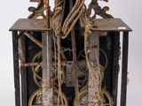 a metal clock with a bunch of gears attached to it