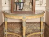une statue représentant une femme assise sur une table devant un miroir