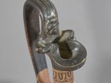 a close up view of a walking stick with a statue on top of it