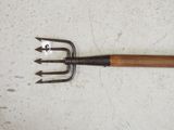 a fork with a wooden handle on a white surface