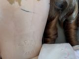 a close up of a doll ' s head with a tattoo on it