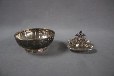 silver plated bowl and a silver plated bowl on a gray surface