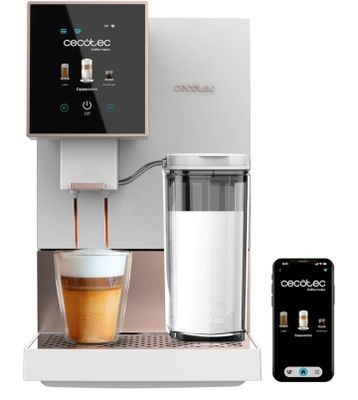 a white coffee machine with a cup of coffee next to it