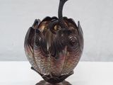 a vase with a bird on top of it on a table