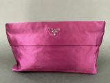 a pink purse with a small logo on the front