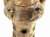 an image of a gold colored vase with holes in it