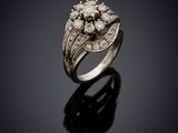 a close up of a diamond ring on a black surface