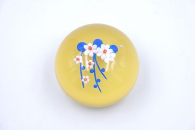 a yellow ball with blue and white flowers on it