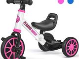 un tricycle rose et blanc à côté d'un ballon bleu et rose