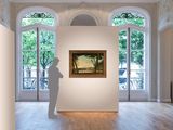 a sculpture of a man standing in front of a painting in a room