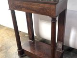 a small wooden table with a marble top on it
