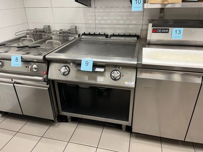 many stainless steel appliances in this kitchen with price tags on them