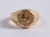 an image of a gold ring with a masonic symbol on it