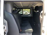 the interior of a white van with the door open and the passenger seat down
