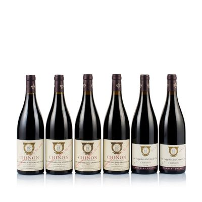 six bottles of red wine lined up in a row