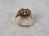 an image of a gold ring with a black diamond