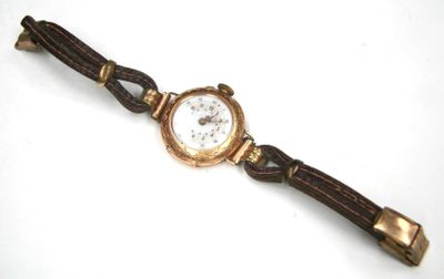 an image of a close up of a wrist watch on a white surface