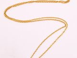 a yellow gold necklace with a ruby and diamond pendant
