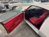 a white car with red leather seats and a red door