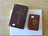 a brown book and a brown book with a cross on it