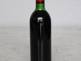 a bottle of wine sitting on a marble table