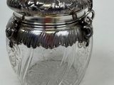 an antique silver plated glass jar with a handle and handle