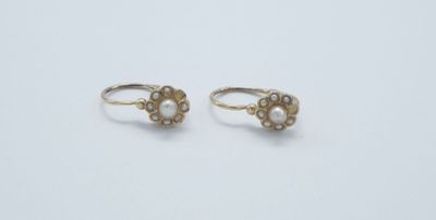 a pair of gold and pearl earrings on a white background