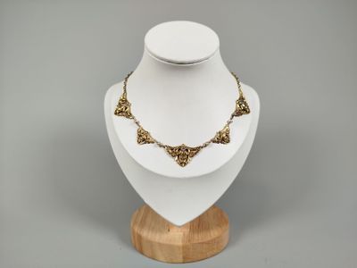 necklace on a wooden stand on a gray background