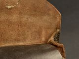 a close up of a brown leather bag with a handle