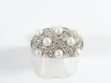 an image of a ring with pearls and diamonds on a white surface