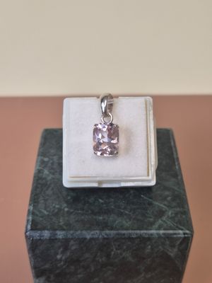 an image of a pink diamond pendant sitting on top of a white box