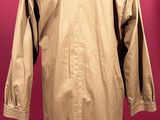 an image of a tan coat on a mannequin stand
